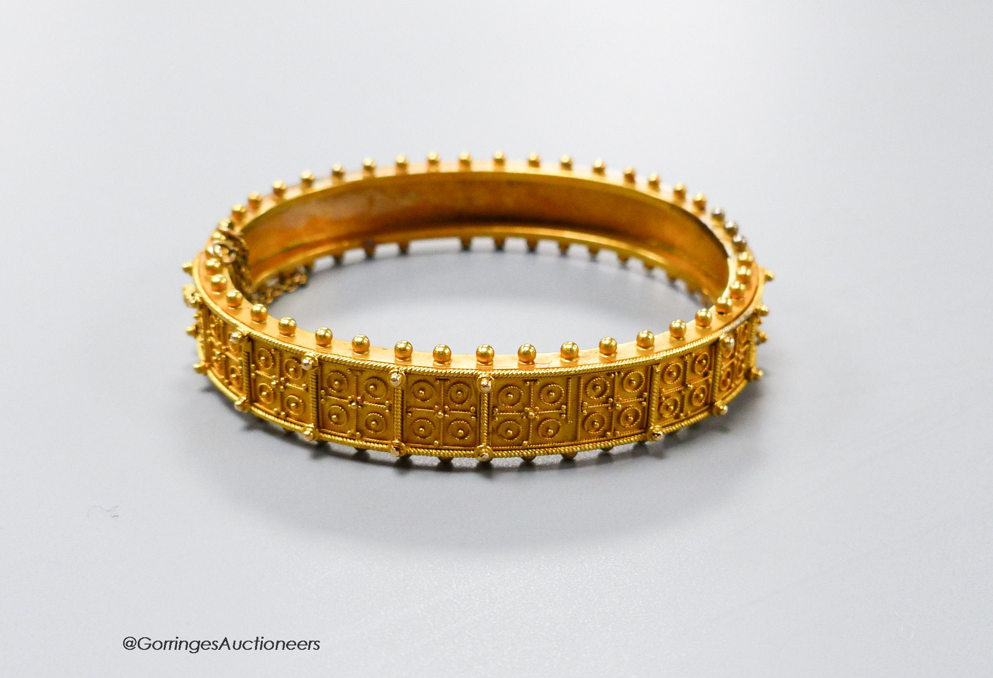 A cased Victorian yellow metal cannetile work hinged bracelet, inner diameter 55mm, 19.1 grams(a.f.).